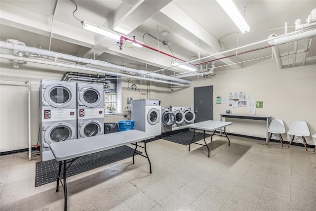 shared laundry area with tile patterned floors, washing machine and dryer, and stacked washer / drying machine