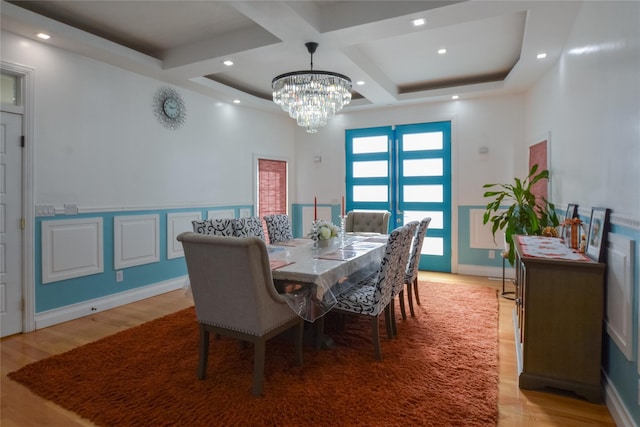 dining room featuring recessed lighting, coffered ceiling, and light wood-style flooring