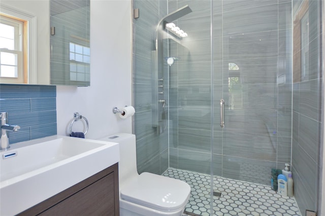 full bathroom with a shower stall, toilet, and vanity