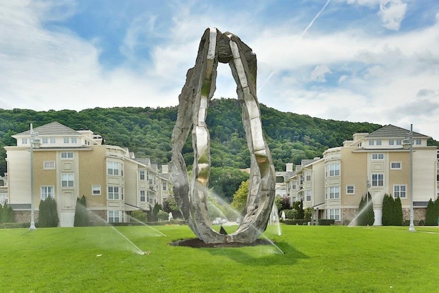 view of home's community featuring a yard and a view of trees