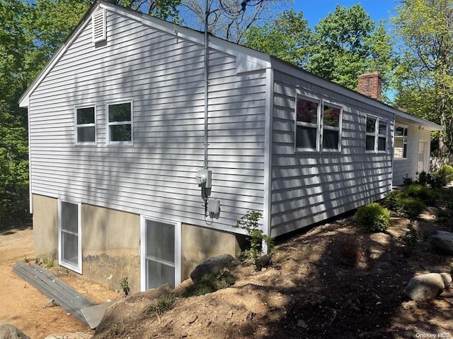 view of home's exterior featuring a chimney