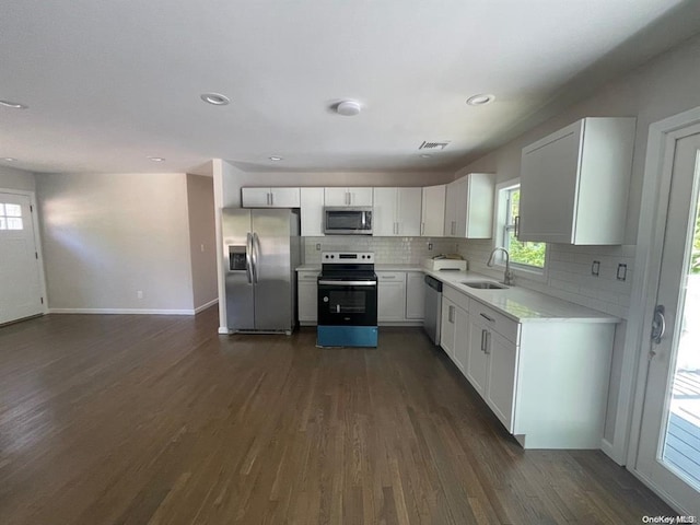 kitchen featuring a sink, stainless steel appliances, visible vents, and dark wood finished floors