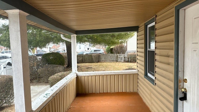 view of patio featuring a porch and fence