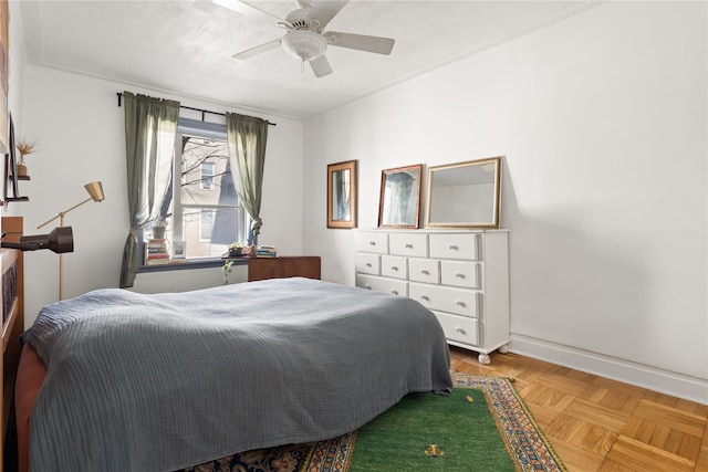 bedroom with baseboards and a ceiling fan