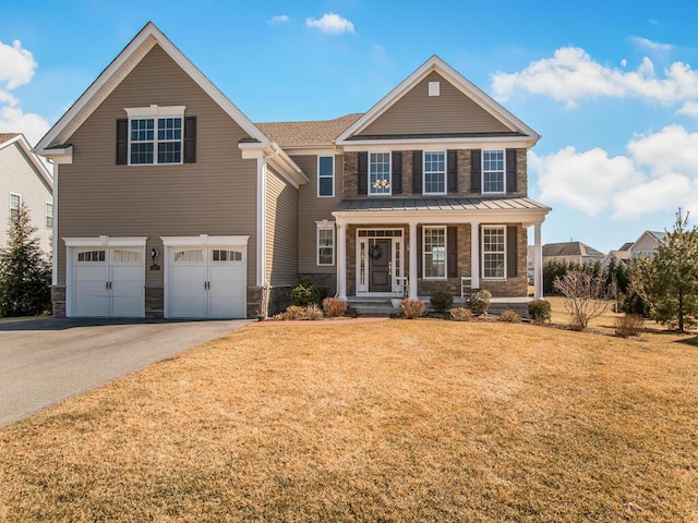 view of front of home with aphalt driveway, a garage, stone siding, and a front yard