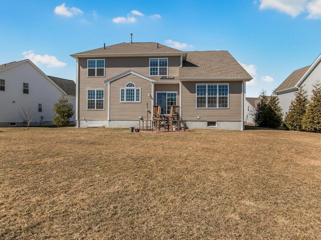 back of property with a lawn and a patio