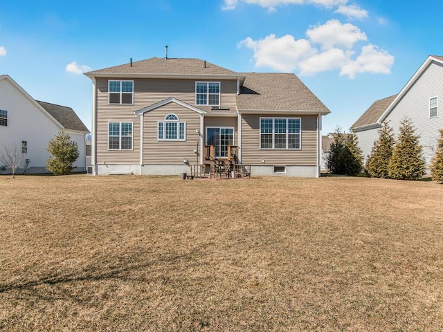 rear view of property with a lawn