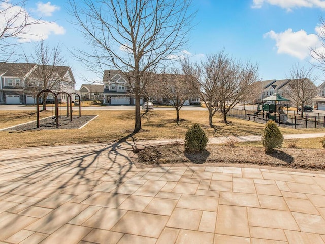 exterior space with a residential view, playground community, and fence