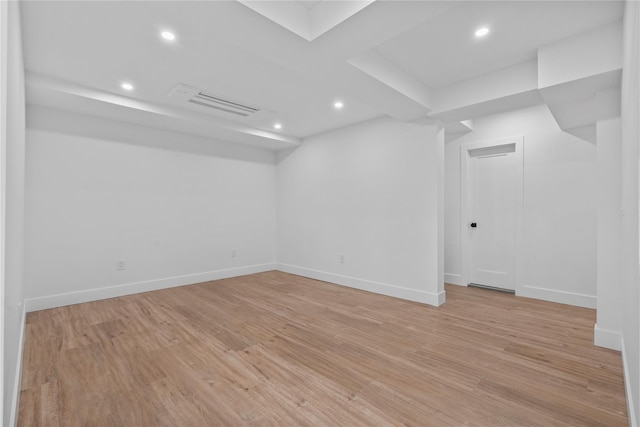 empty room with visible vents, baseboards, and light wood-style floors