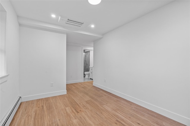 spare room with visible vents, a baseboard heating unit, recessed lighting, light wood finished floors, and baseboards