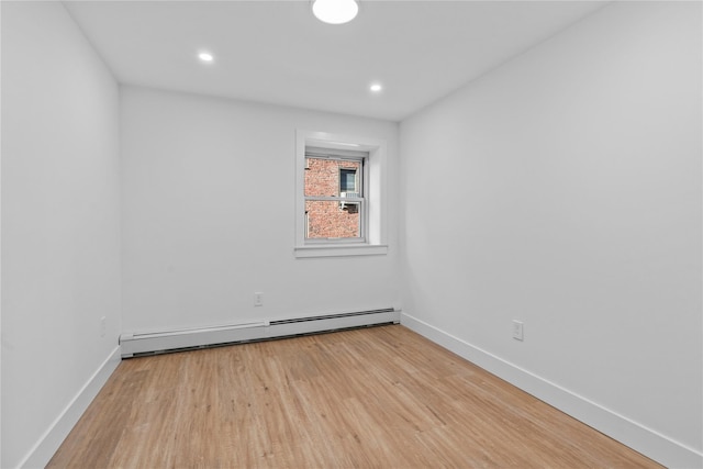 unfurnished room featuring recessed lighting, light wood-type flooring, baseboards, and baseboard heating