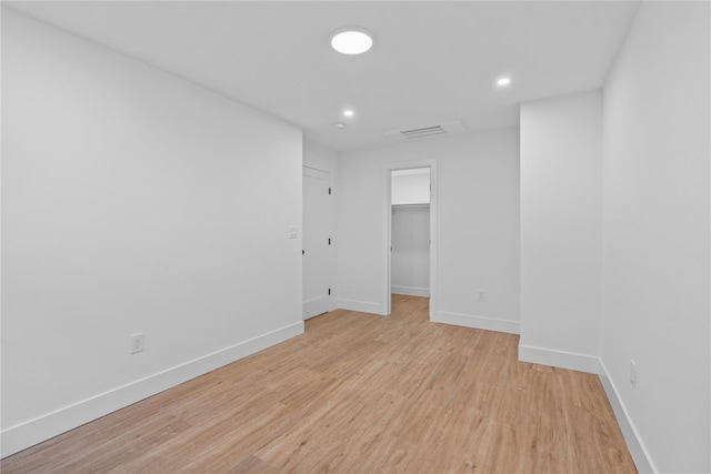 empty room featuring recessed lighting, visible vents, baseboards, and light wood-style floors