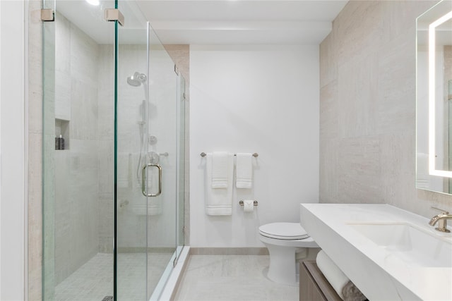 bathroom with baseboards, toilet, a stall shower, and vanity