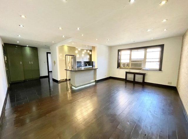 unfurnished living room with recessed lighting, baseboards, and dark wood finished floors