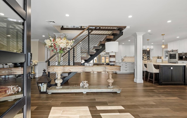 staircase with visible vents, ornamental molding, recessed lighting, decorative columns, and wood tiled floor