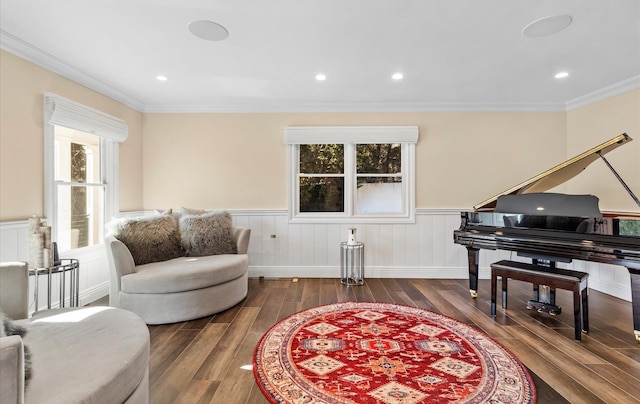 living area with wainscoting, recessed lighting, ornamental molding, and wood finished floors