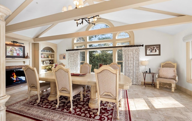 dining area with ornate columns, built in features, and lofted ceiling