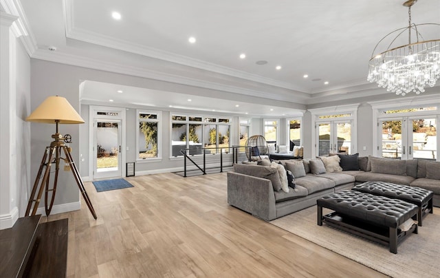 living room featuring light wood finished floors, recessed lighting, french doors, and crown molding