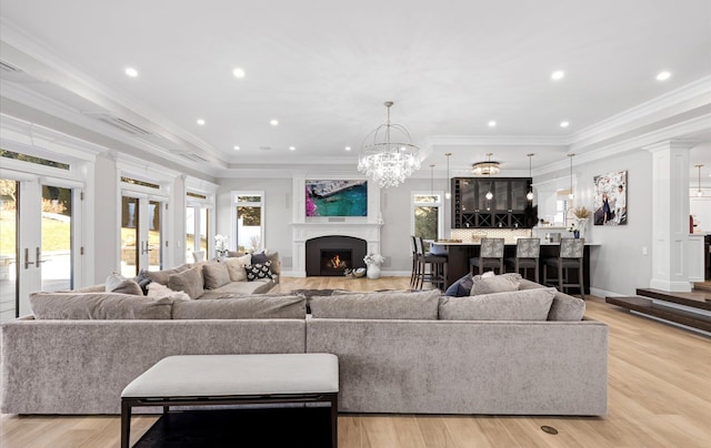 living area with crown molding, french doors, and a wealth of natural light