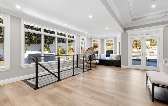 living area with a wealth of natural light, french doors, and an upstairs landing