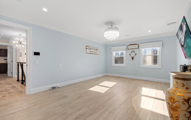 interior space with light wood finished floors, visible vents, baseboards, ornamental molding, and a notable chandelier