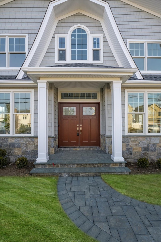 property entrance with stone siding and covered porch