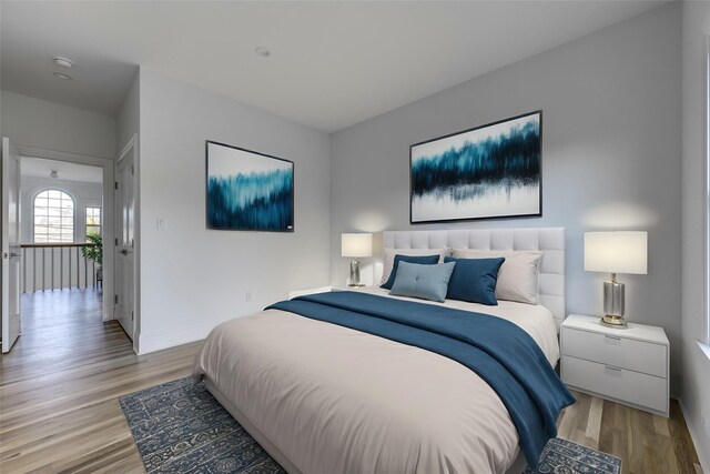 bedroom with baseboards and light wood-type flooring