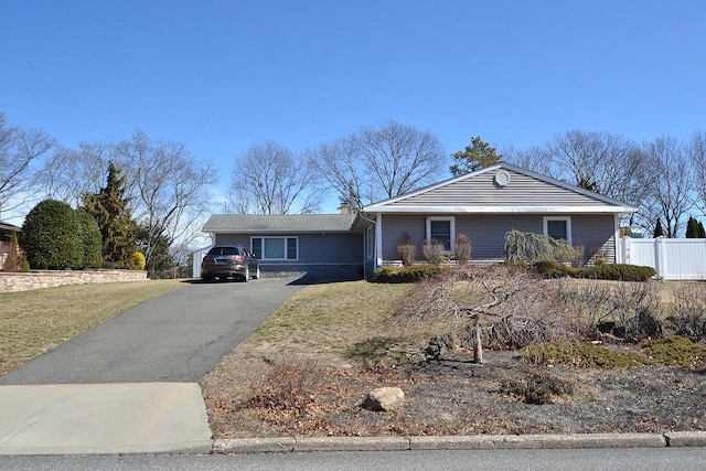 single story home with driveway and fence