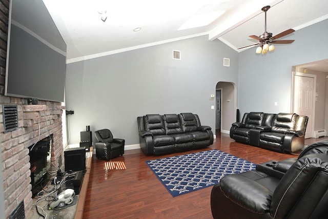 living area with wood finished floors, visible vents, lofted ceiling with beams, arched walkways, and ornamental molding