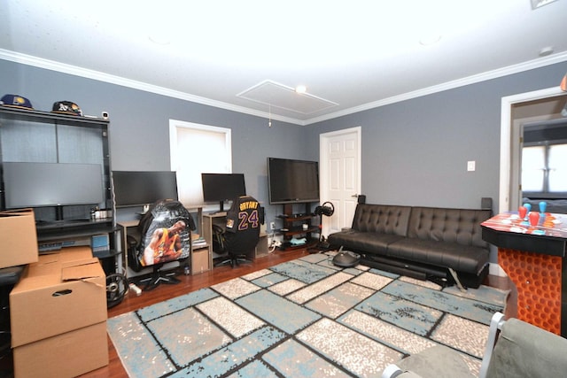 living area featuring attic access, wood finished floors, and ornamental molding