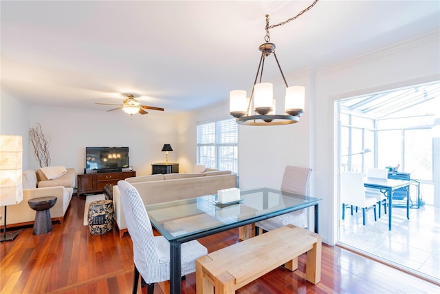 dining space featuring ornamental molding, ceiling fan, and wood-type flooring