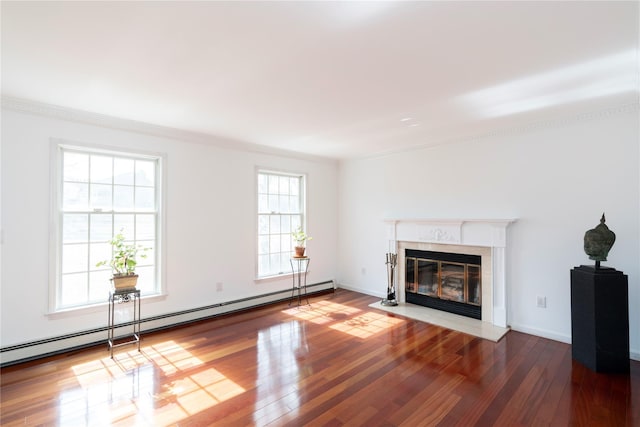 unfurnished living room featuring a premium fireplace, a baseboard heating unit, baseboards, and wood-type flooring