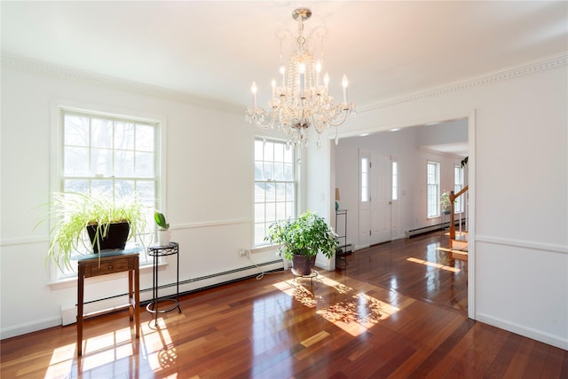 foyer featuring a notable chandelier, hardwood / wood-style floors, a baseboard radiator, baseboards, and baseboard heating