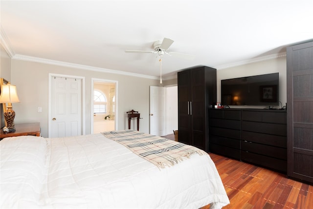 bedroom with ornamental molding, ensuite bath, ceiling fan, and wood finished floors