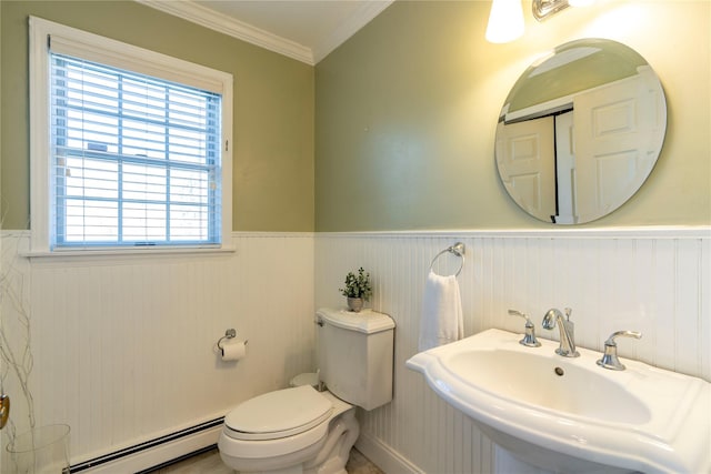 bathroom featuring a sink, baseboard heating, and wainscoting