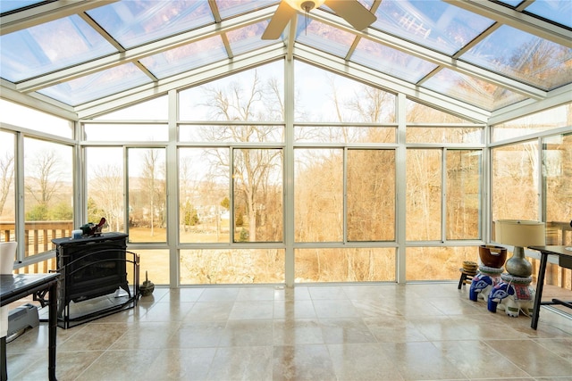 sunroom / solarium featuring lofted ceiling with skylight and a ceiling fan