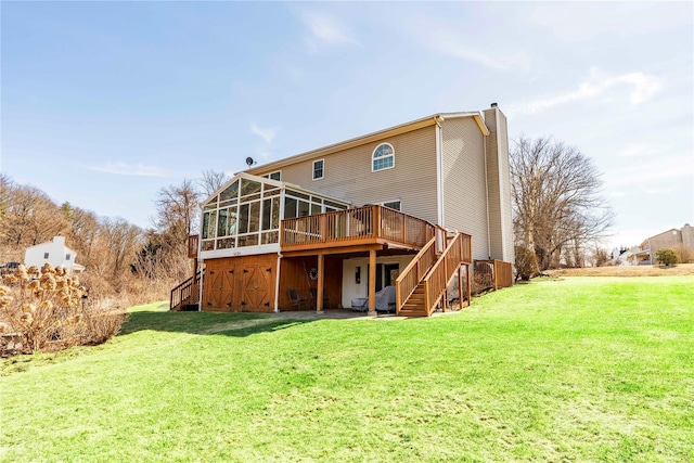 rear view of house featuring a deck, stairway, a yard, and a chimney