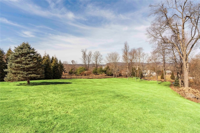 view of yard featuring a rural view and fence