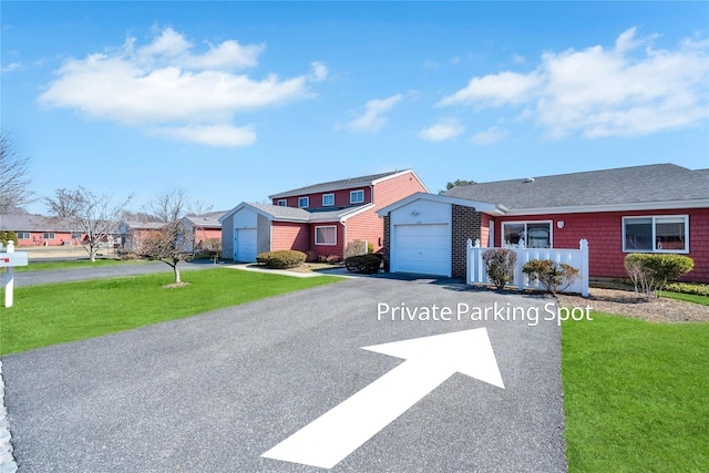 view of front of property with driveway, an attached garage, and a front lawn