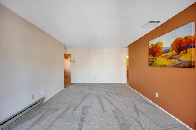 empty room with baseboard heating, carpet, and visible vents