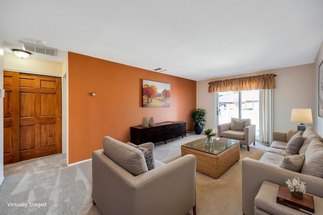 living room with visible vents and light carpet