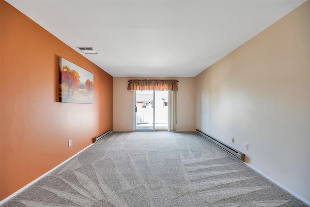 spare room with a baseboard heating unit, visible vents, and light carpet