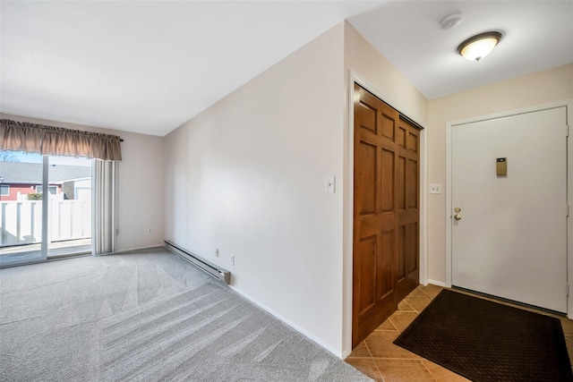 entrance foyer with light colored carpet, a baseboard heating unit, and baseboards