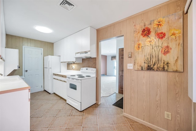 kitchen featuring visible vents, under cabinet range hood, white appliances, white cabinets, and light countertops