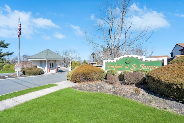 community / neighborhood sign with a lawn