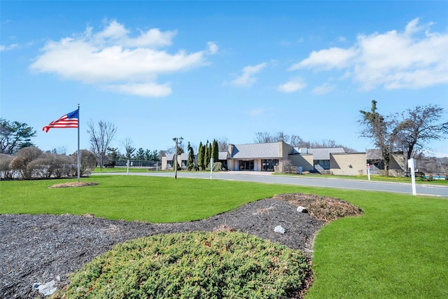 view of home's community featuring a lawn