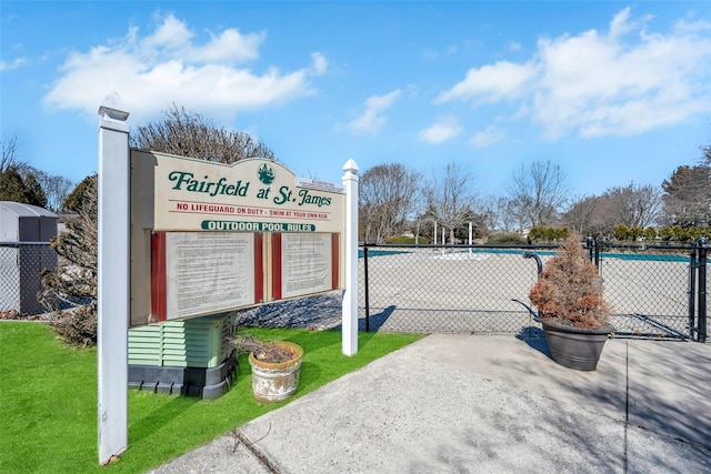 view of community with a yard and fence