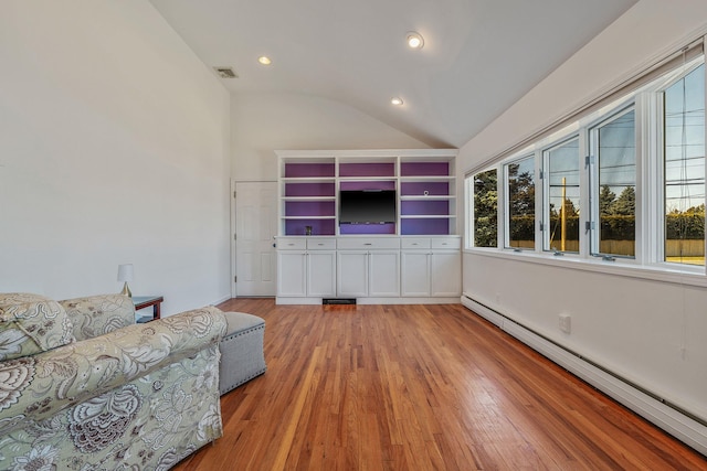 unfurnished living room with a baseboard heating unit, vaulted ceiling, visible vents, and light wood-type flooring