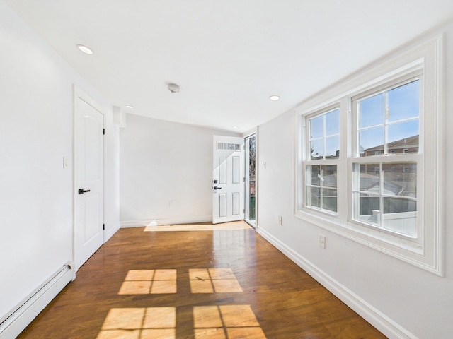 foyer with recessed lighting, a baseboard radiator, baseboards, and wood finished floors