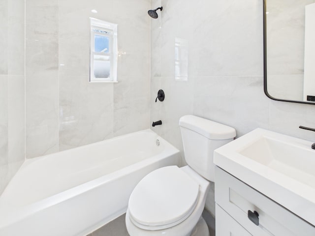 bathroom with shower / bath combination, toilet, tile walls, and vanity